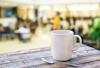 Coffee cup on wooden table with blurr background