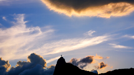 Silhouette of the Corcovado Mountain and Christ the Redeemer among Clouds at Dusk - Rio de Janeiro,...