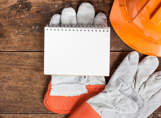 White card in  safety glove on wooden