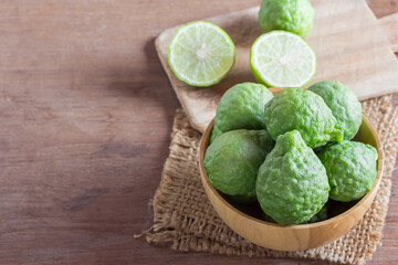 fresh bergamot and bergamot slice in wooden bowl