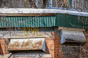 A fragment of the facade of an old industrial building on a spring day