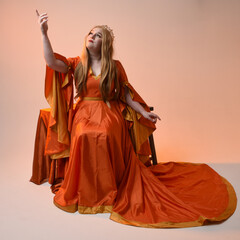 Full length portrait of plus size blonde woman, wearing historical medieval fantasy gown, golden...