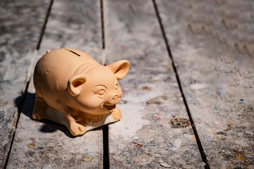 pink piggy bank to save on the table of a poor house - saving concept