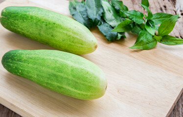 Fresh cucumber on wooden table