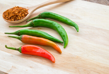 chili powder and fresh chili on cutting board