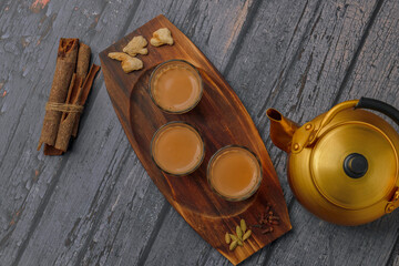Fresh milk masala tea or Indian Kadak Chai.  Herbal tea in glass cups. Locally called mini cutting...
