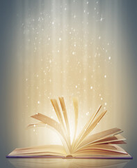 Magic, glowing pages and story with book, glitter and literature on a grey studio background....