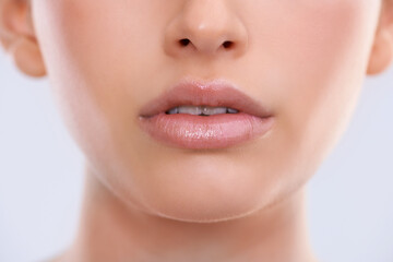 Closeup, face and lips with woman for beauty, makeup with shine and cosmetics for dermatology on...