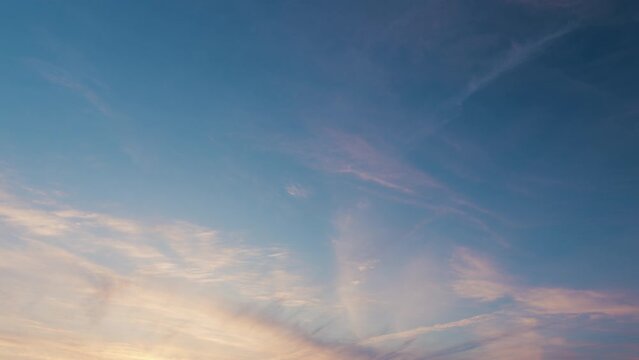 Blue cloudy sky with white cirrus clouds. Clear sky with few wispy cirrus clouds.