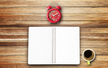 Top view with paper notepad,red alarm clock and coffee cup on wood table background
