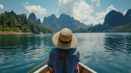 Foto op Canvas woman with hat relax and sightseeing on Thai longtail boat in Ratchaprapha Dam at Khao Sok National Park © Naila