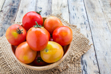 Fresh tomatoes on wooden table
