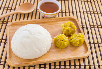 Buns and dumpling in wooden plate