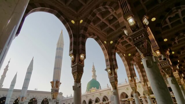 Static general view green dome and Moorish pattern arches of Nabawi mosque in Al Madinah, Saudi Arabia. 