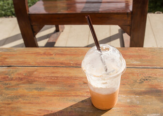Ice coffee on a wooden table