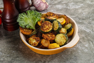 Roasted young zucchini in the plate