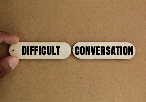 wood with the word DIFFICULT CONVERSATION. difficult conversation concepts