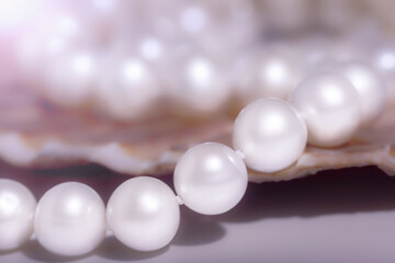 beautiful women's necklace made of natural white pearls , photographed at close range , women's jewelry close-up