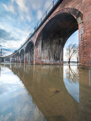 Worcester arched railway viaduct,surrounded by floods,from river Severn,after heavy rains,Worcestershire,England,United Kingdom.