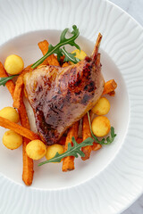 grilled duck with vegetables and sauce on a plate