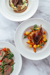 grilled duck with vegetables and sauce on a plate