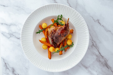 grilled duck with vegetables and sauce on a plate