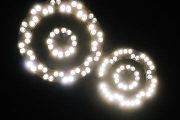 Valmiera, Latvia - March 20, 2024 - surgical lights with multiple illuminated LED bulbs against a...