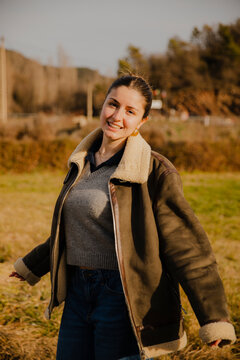 Girl in Jacket and Wide Pants in Mountains smiling