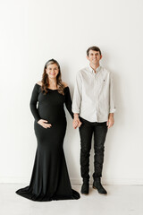 Expectant couple in stylish black and white attire
