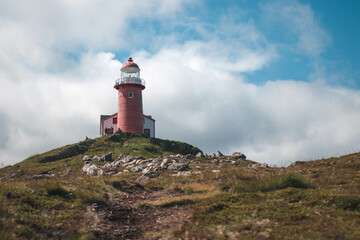 Ferryland lighthouse with a shadow and cloudy skies