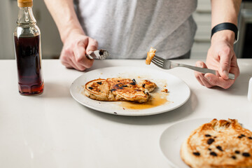 eating pancakes with syrup at home on the weekend