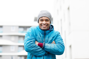 Young man, mixed race, having cold in the city