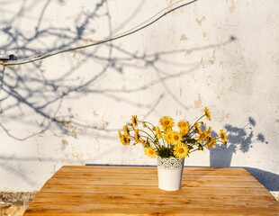 a bouquet of wildflowers in a vase on a wooden table
