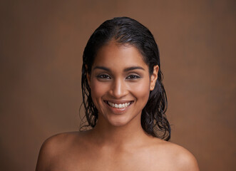Hair, wet or portrait of happy woman in studio for beauty, wellness or shine cosmetics on brown...