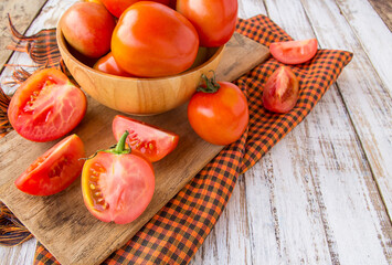 Fresh tomatoes on white wooden table