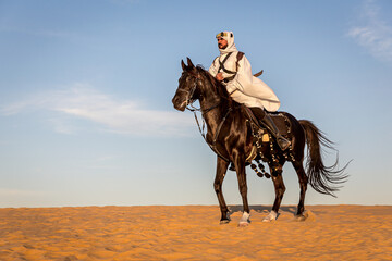 Arabian horseback archer riding his stallion and aiming at targets with his bow and arrow