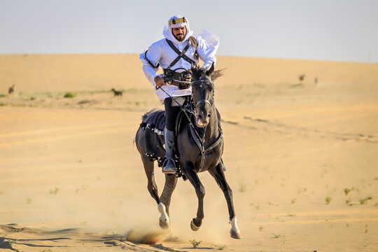 Arabian horseback archer riding his stallion and aiming at targets with his bow and arrow