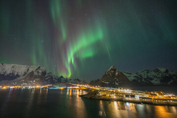 A city view with colorful northern light on Lofoten island , Norway