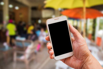 Hand holding smart phone with blur background