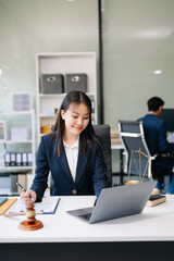 Asian woman lawyer working and gavel, tablet, laptop in front, Advice justice and law concept..