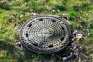Sewerage with hatches in grassy nature