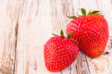 Fresh strawberries on white wooden table
