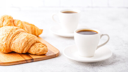 Breakfast with coffee and croissants