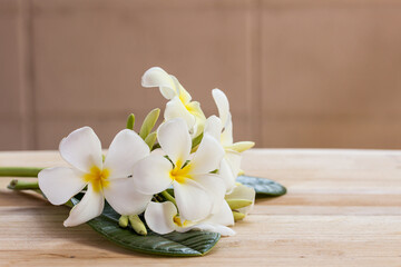 Plumeria flowers on wooden table and grunge texture backgrounds