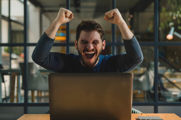 Celebrating Victory: Man Cheers at Laptop Screen for Success