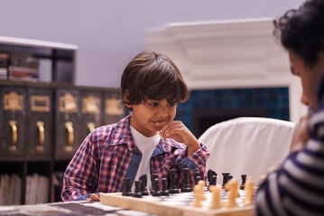 Child, father and chess game with strategy or checkmate move with knight, king or queen. Son,...