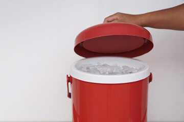 Close up hand open lid of red bucket of ice. Concept, kitchenware container for keep cool of ice,...