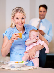 Portrait, mother and baby with juice and breakfast in the morning with businessman leaving for work. Woman, food and eating fruit with little child or kid for healthy diet and father in background