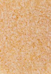 Top View of Rice Heap Background with Copy Space in Vertical Orientation