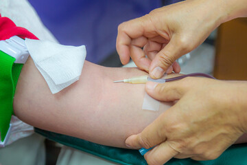 Nurse taking blood draw in hospital.